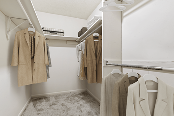 a walk in closet with white walls and a white mirrored medicine cabinet at Eastchester Ridge Apartments, High Point, 27262